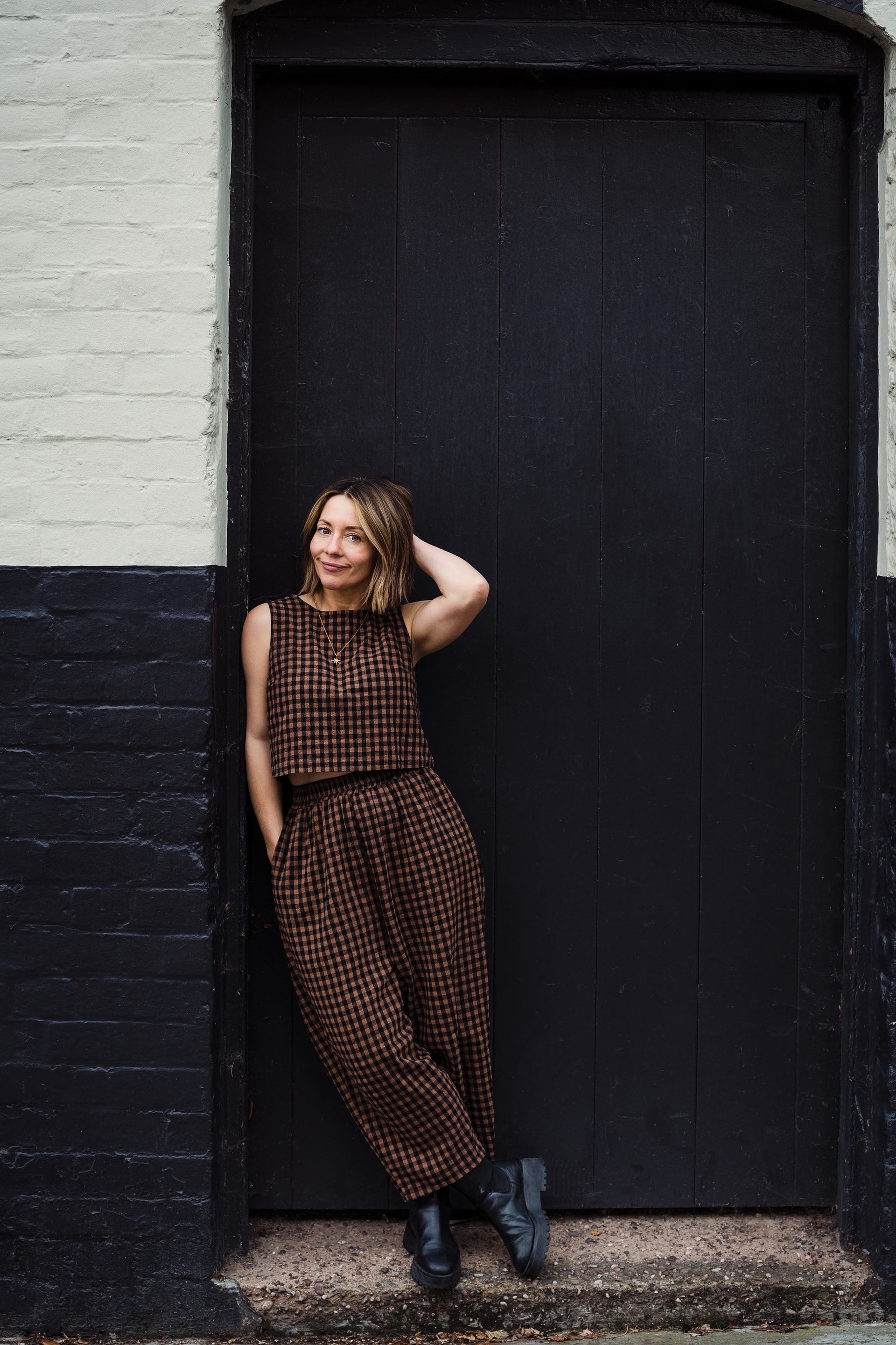 Charlotte from Indie Love Photography leaning against a black and white wall in Shrewsbury, Shropshire