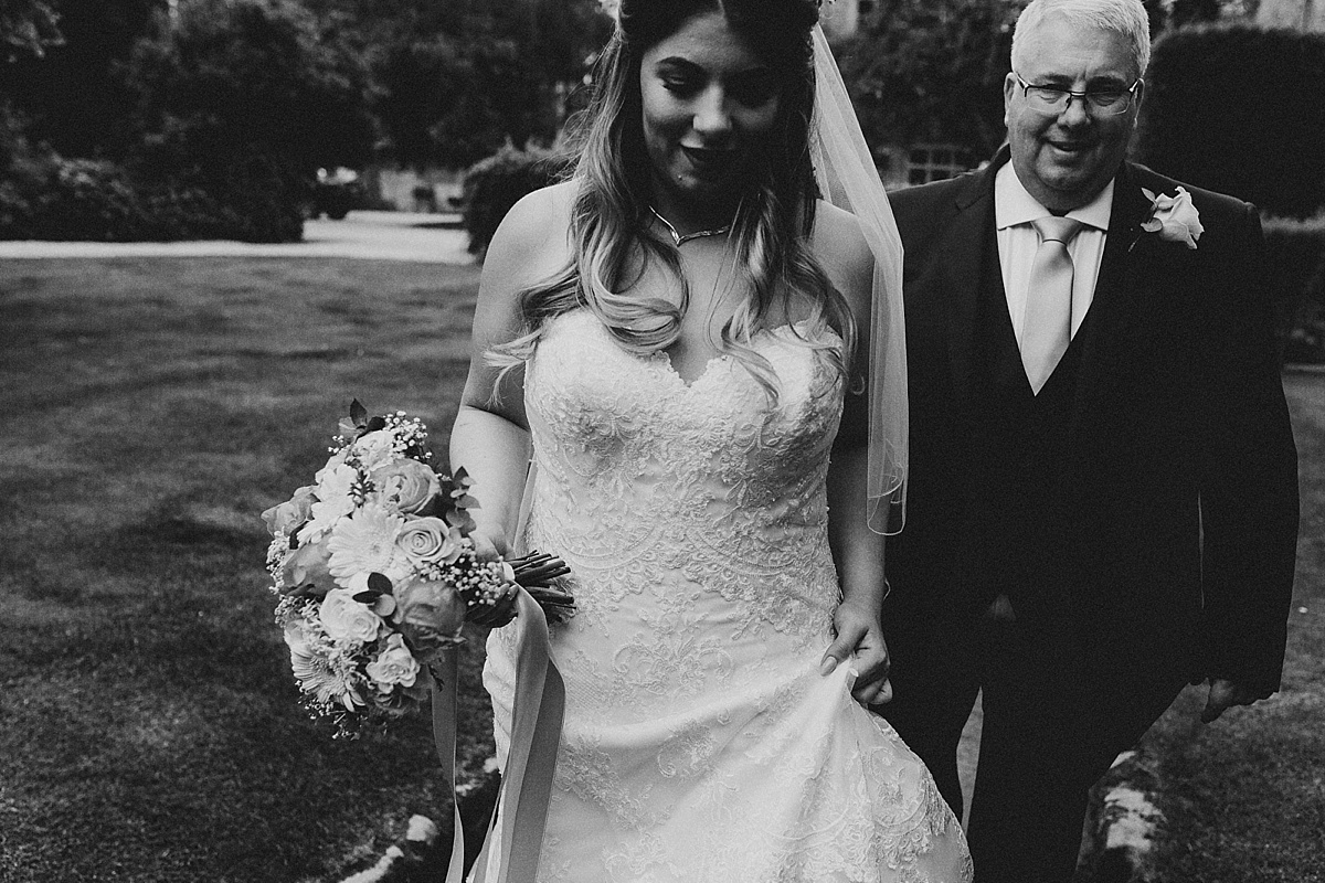 Bride and father walking to ceremony at Pim Hill Barn, Shropshire