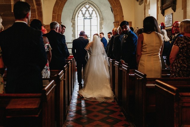 Bride walking down the aisle in Bobbington church