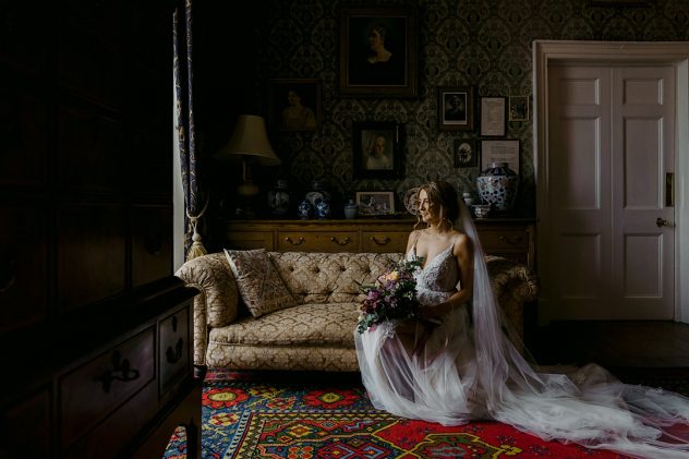 Bride sitting on sofa in Homme House, a Herefordshire Wedding Venue