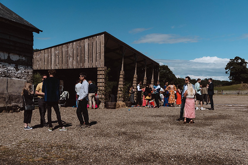 Blue skies and wedding guests at Wilde Lodge