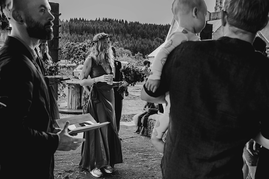 Bride holds a can of beer during Wilde Lodge outdoor ceremony