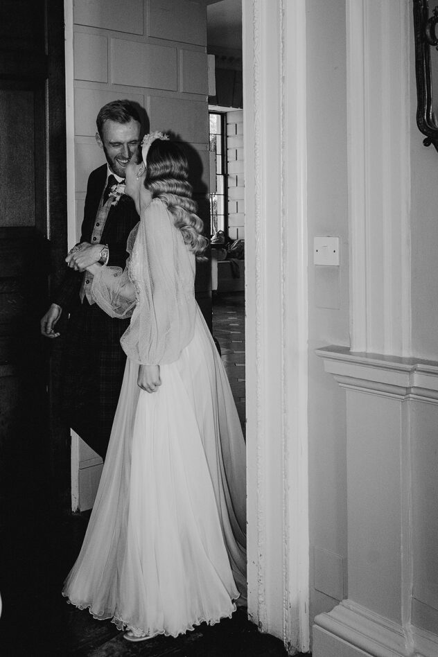 A joyful, unposed candid of the newlyweds entering wedding reception at Davenport House, Shropshire
