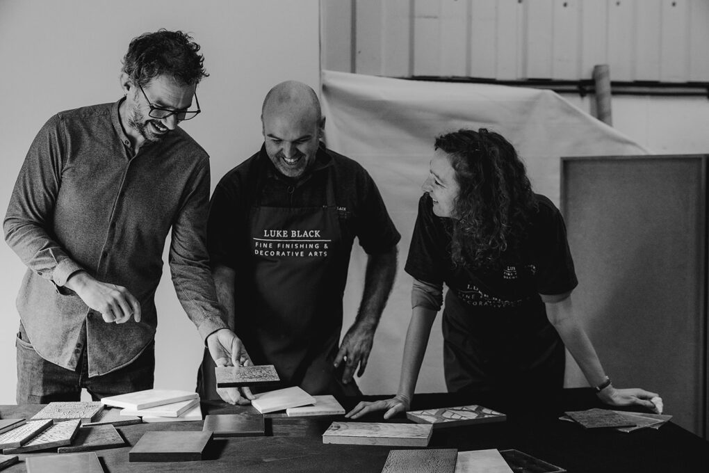 Staff at Luke Black Ltd laughing with client whilst looking at samples part of brand storytelling collection