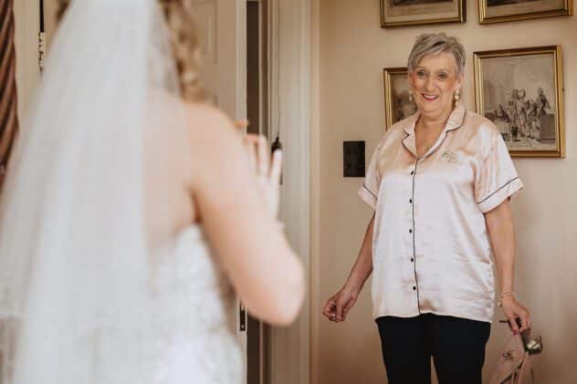 Mother of the bride seeing daughter in her wedding dress
