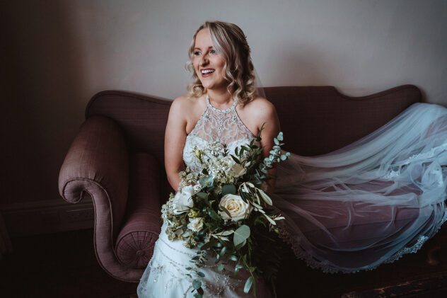 Indie sitting on a pink velvet sofa at Iscoyd Park