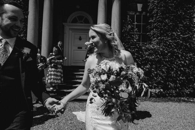 Bride and Groom smiling after confetti throw at Iscoyd Park