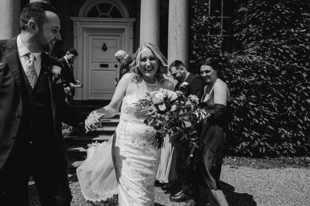 Bride and Groom smiling after confetti throw at Iscoyd Park