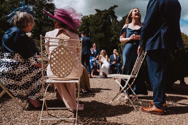 Guests create frame around bride and groom during drinks reception at Iscoyd Park