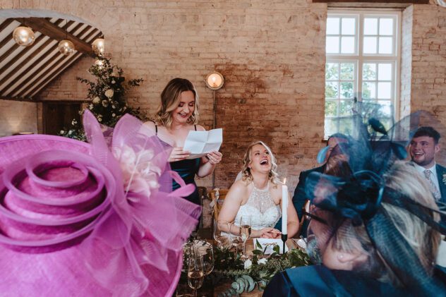 Bride laughs during maid of honour speech at Iscoyd Park wedding