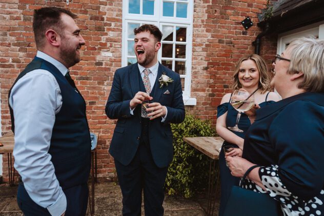 Guest laughing during drinks reception at Iscoyd Park wedding