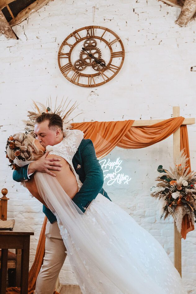 Groom dips bride during first kiss at Stanford Farm Wedding