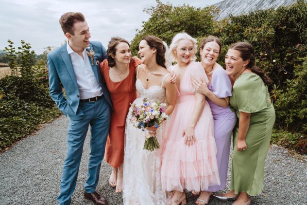 Bridal squad laughing during relaxed group photos, Shropshire wedding photography
