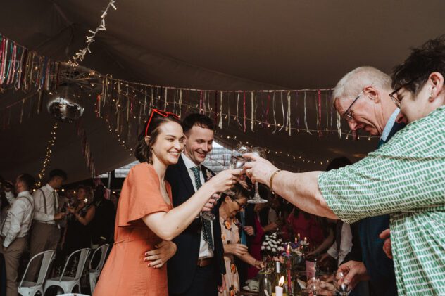 Guests cheers after wedding speeches, Shropshire wedding reception