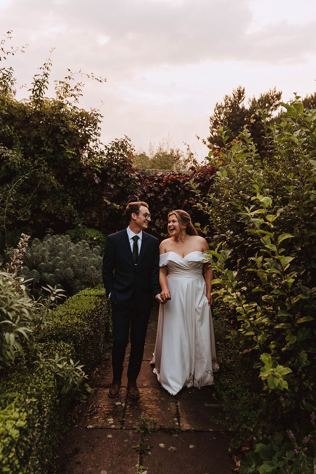 Golden hour photos of Bride and groom strolling through the grounds of Pimhill barn at Pimhill barn wedding