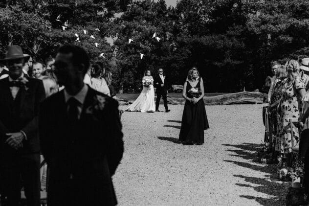 Doves fly over bride as she walks down the aisle at Pimhill barn wedding
