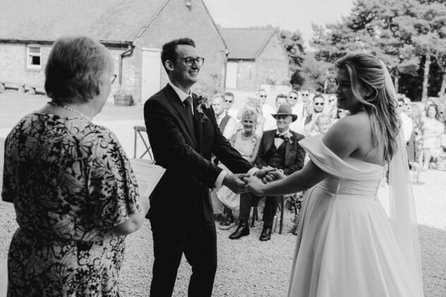 Bride and groom exchange vows at at Pimhill barn wedding