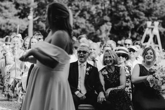 Guests laughing during ceremony at Pimhill barn wedding