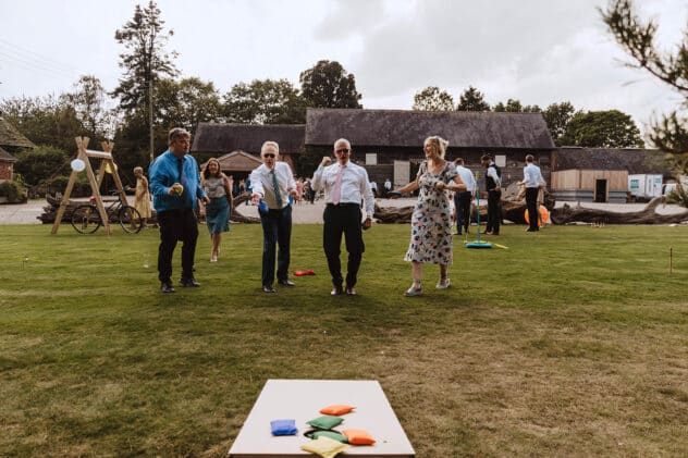 Guests play hoopla at Pimhill barn wedding