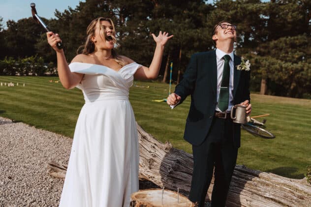 Bride celebrates after beating groom at lawn games at Pimhill barn wedding