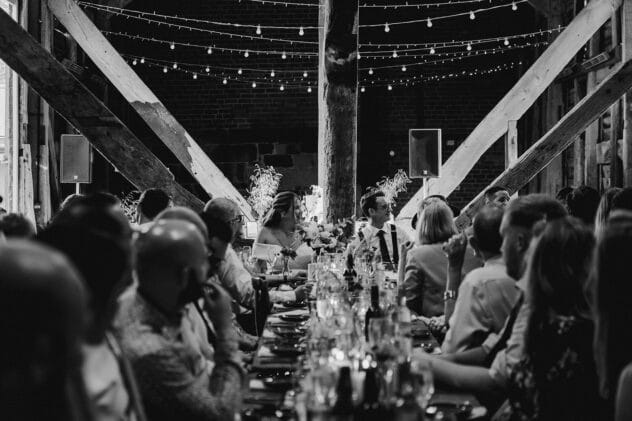Bride and groom watching speeches at Pimhill barn wedding