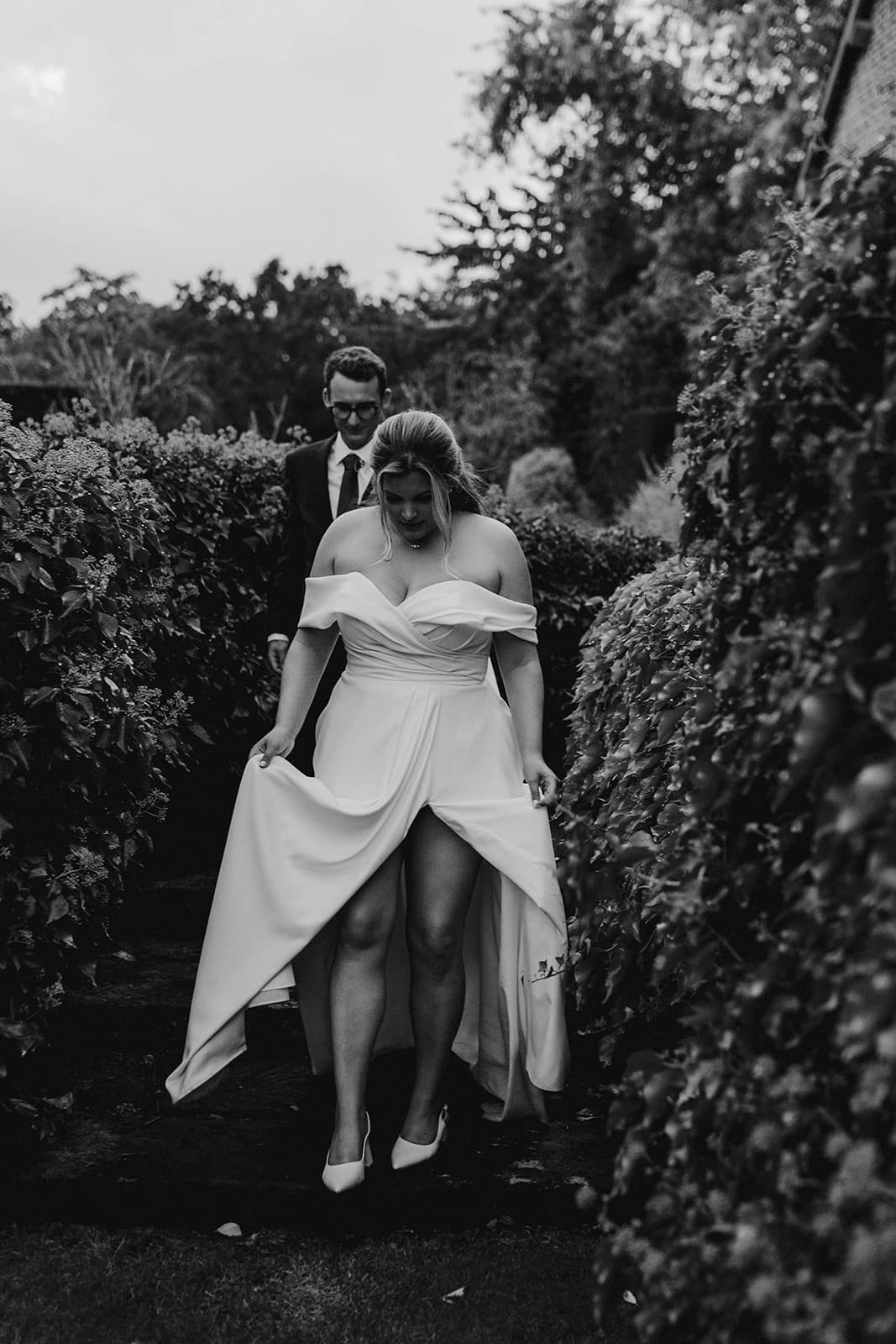 Candid wedding photography in Shropshire. Bride and groom strolling through the grounds of Pimhill barn at Pimhill barn wedding