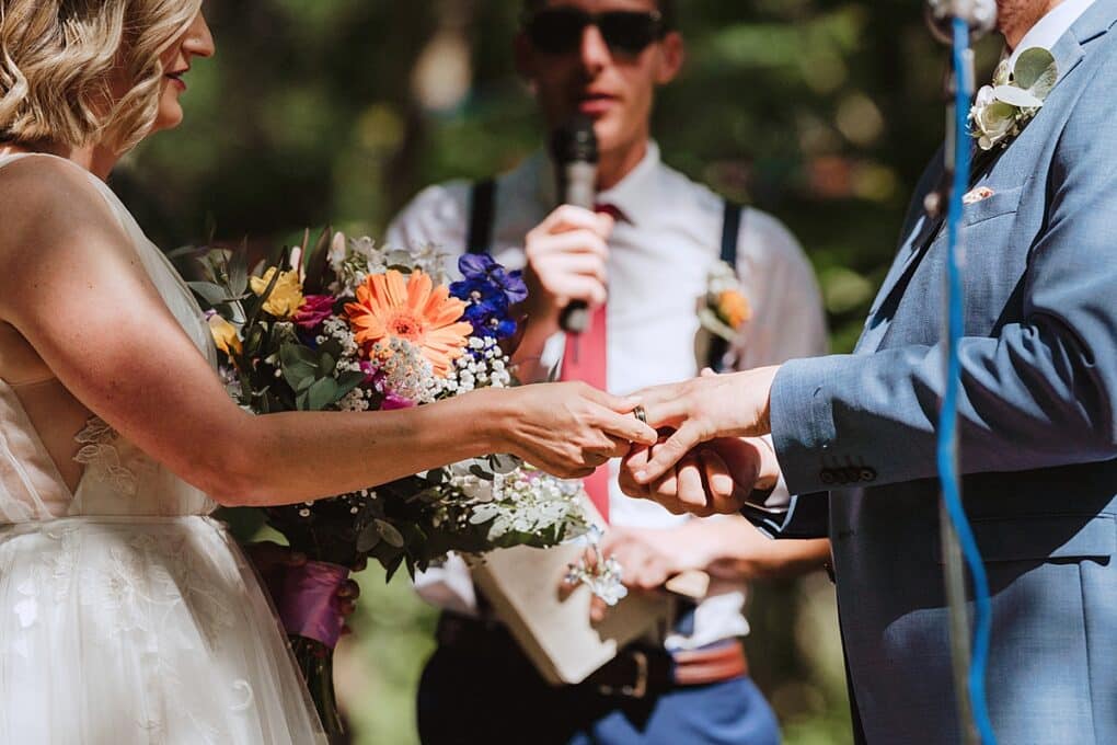 Candid Shropshire wedding photography of bride and groom exchanging rings