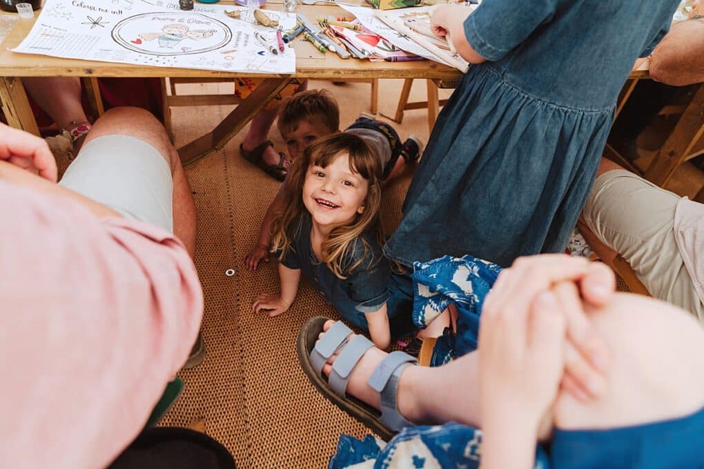 Candid Shropshire wedding photography of kids under table during wedding reception