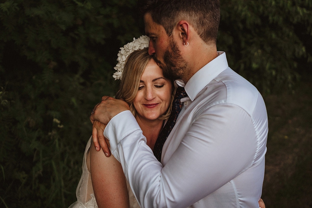 Authentic Shropshire wedding photography groom kissing bride on the top of her head