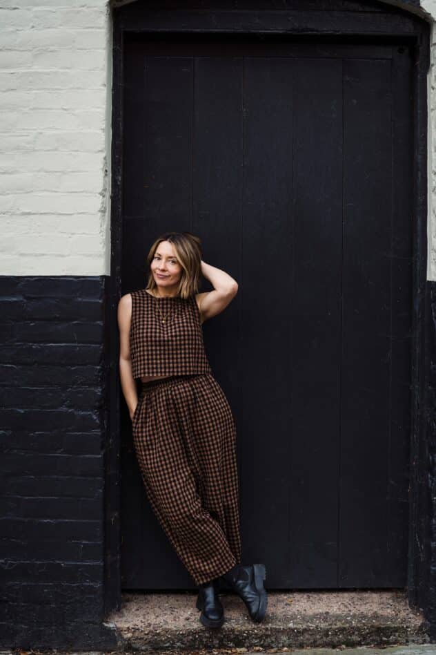 Charlotte from Indie Love Photography leaning against a black and white wall in Shrewsbury, Shropshire
