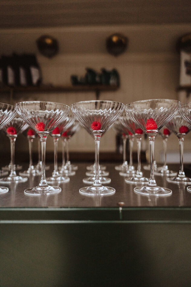 French Martini glasses with raspberrys in lined up at No.131 The Promenade Cheltneham