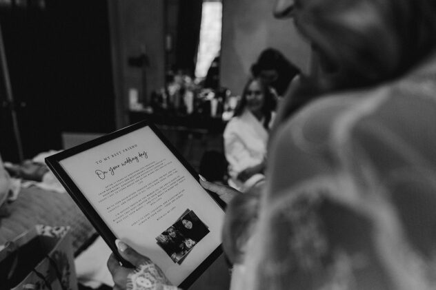 Candid photo of bride reading wedding card