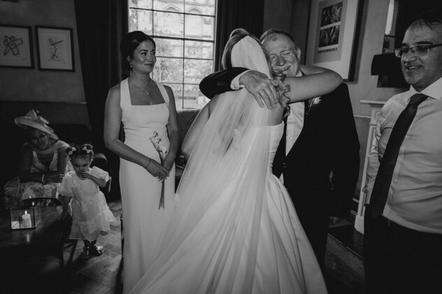 Candid documentary wedding photo of father of the bride hugging the bride at No 131 The Promenade