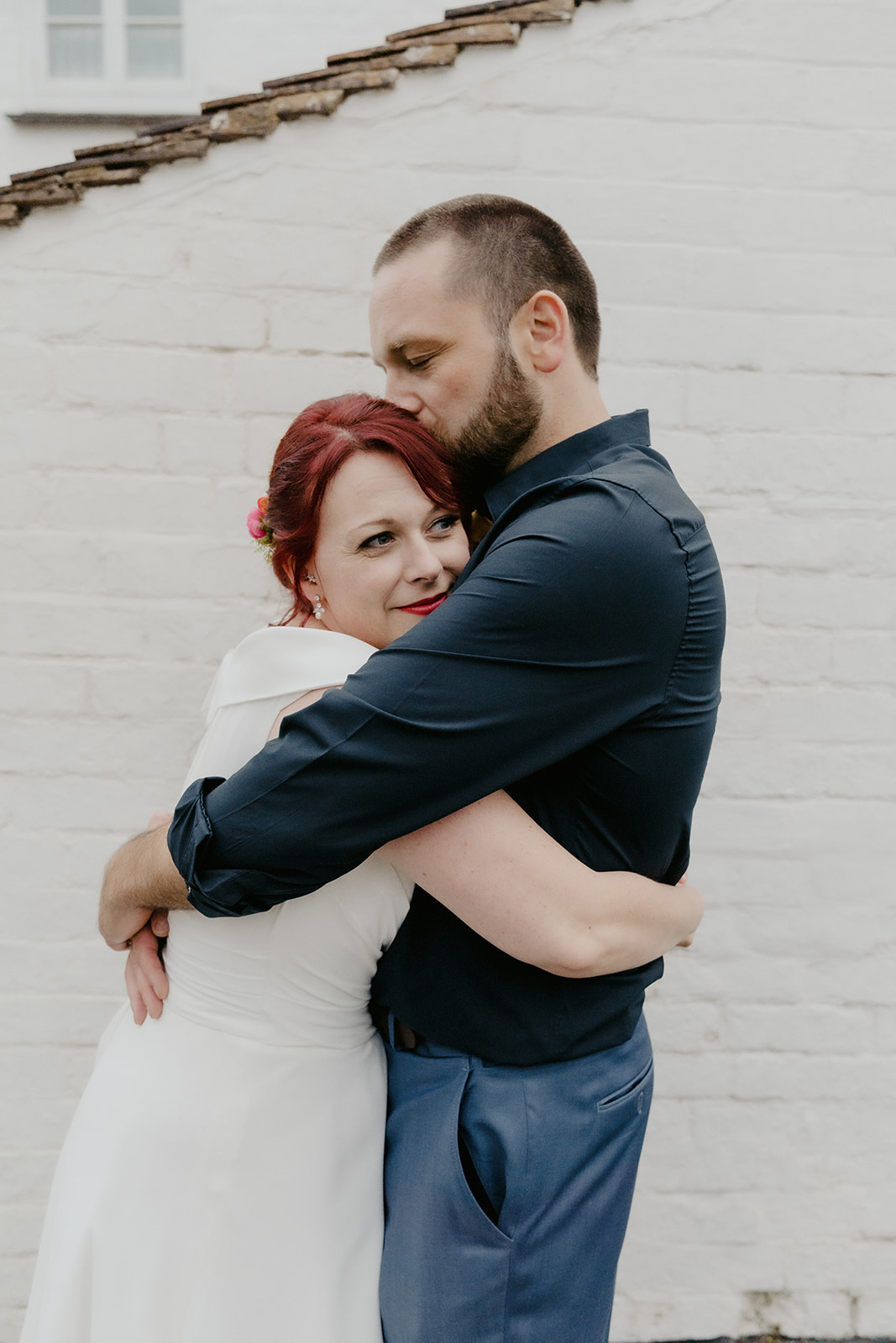Natural and relaxed wedding photography in Shropshire: A camera-shy couple cuddling together without being posed or directed.