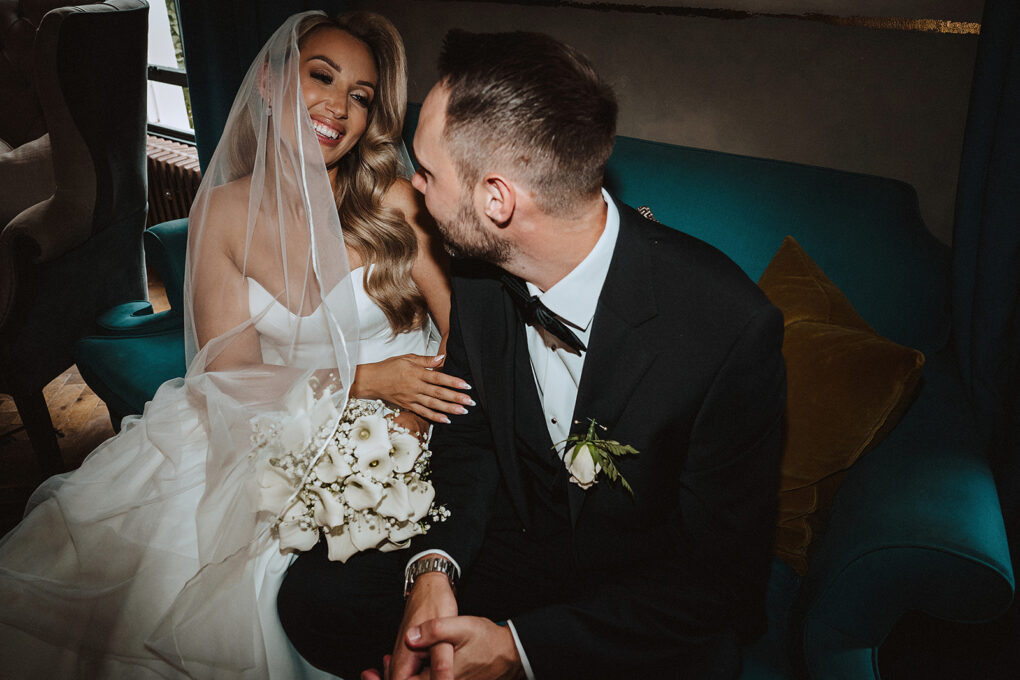 Candid documentary moment of Tara and Sam sharing a laugh at their No. 131 Cheltenham wedding