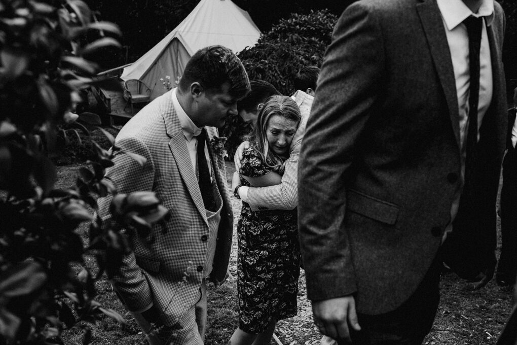 A tender moment between guests during a relaxed, intimate wedding at Wilde Lodge