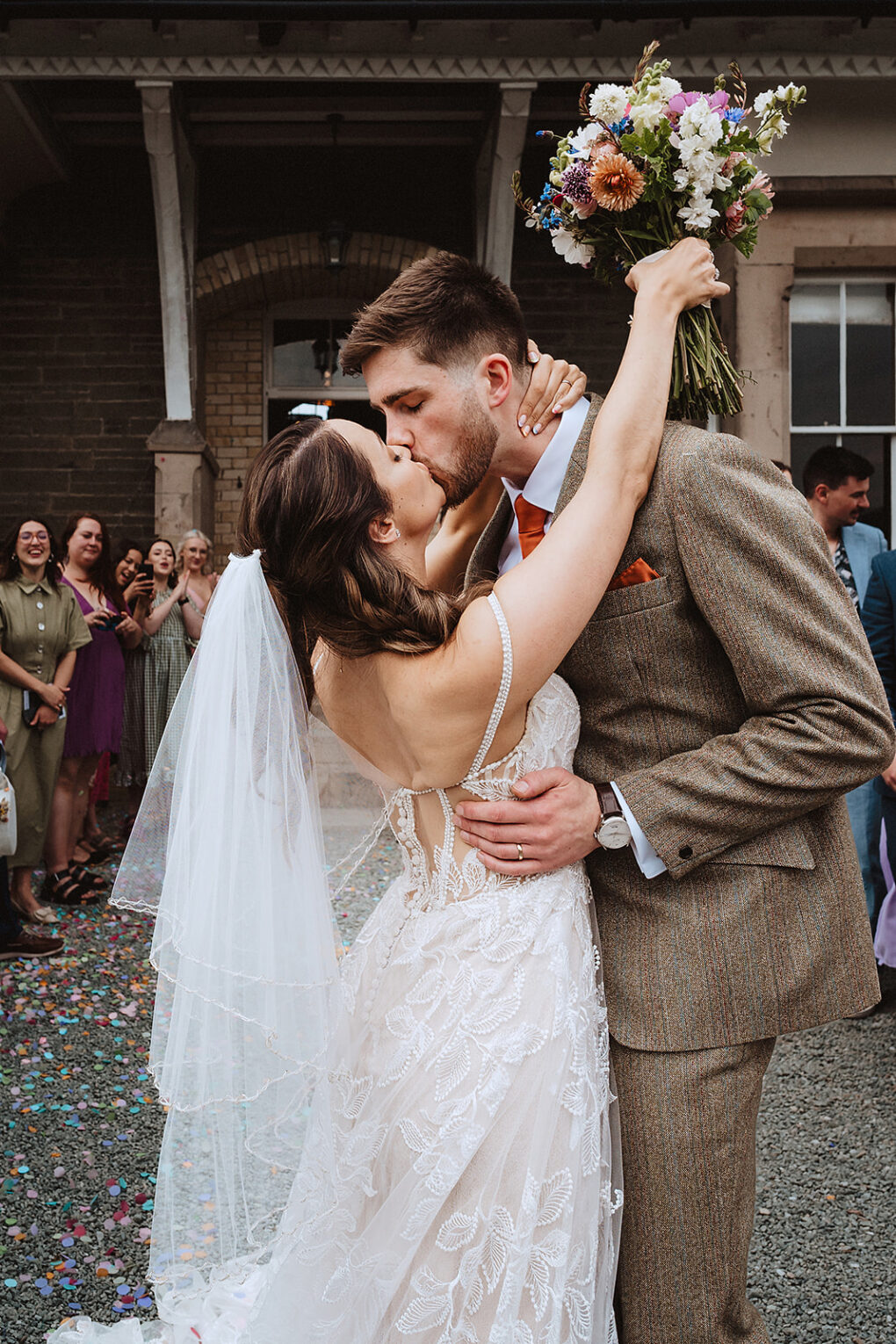 Post confetti kiss at a Wilde Lodge wedding on the Shropshire border